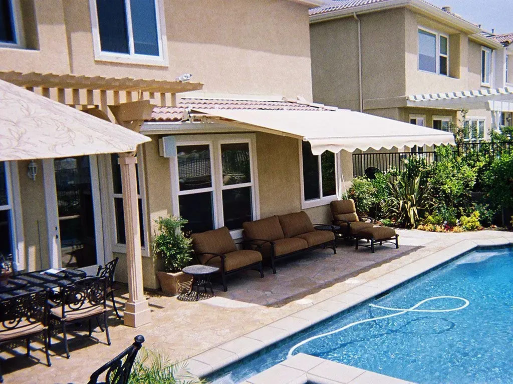 A house with a swimming pool and patio furniture