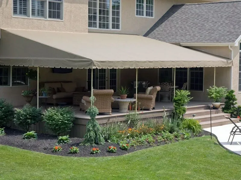 A house with a covered porch with a canopy over it